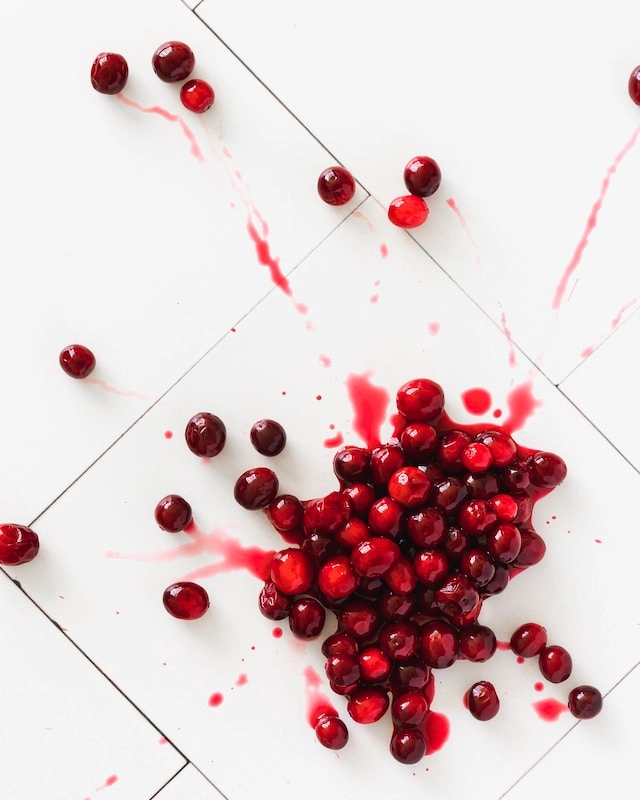 red round fruits on white surface: Cranberry Explosion